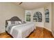 Comfortable bedroom featuring hardwood floors and arched windows at 2308 W Jetton Ave, Tampa, FL 33629