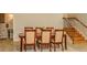 Elegant dining room with a wooden table, seating for six, and a staircase with iron railings at 2308 W Jetton Ave, Tampa, FL 33629