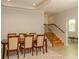 Elegant dining room with a wooden table, seating for six, and a staircase with iron railings at 2308 W Jetton Ave, Tampa, FL 33629