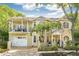 Elegant two-story home features a balcony, arched windows, and a well-maintained front yard at 2308 W Jetton Ave, Tampa, FL 33629