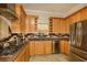 Bright kitchen featuring stainless steel appliances, custom cabinets, tile backsplash, and a modern range hood at 2308 W Jetton Ave, Tampa, FL 33629