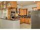Bright kitchen featuring stainless steel appliances, custom cabinets, tile backsplash, and a modern range hood at 2308 W Jetton Ave, Tampa, FL 33629