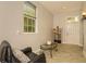 Cozy living room with a comfortable leather chair, a glass-topped coffee table, and plenty of natural light at 2308 W Jetton Ave, Tampa, FL 33629