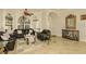 Spacious living room featuring arch windows, tile floors, and comfortable leather sofas at 2308 W Jetton Ave, Tampa, FL 33629