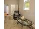 Cozy living room with a comfortable leather chair, a glass-topped coffee table, and plenty of natural light at 2308 W Jetton Ave, Tampa, FL 33629