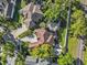 A bird's eye view of a single-Gathering home with mature trees, lawn, and a screened-in pool in a quiet neighborhood at 2309 Valrico Forest Dr, Valrico, FL 33594