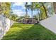 Lush backyard featuring mature trees and a screened-in patio at 2309 Valrico Forest Dr, Valrico, FL 33594