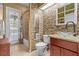 Unique bathroom with textured walls, glass bowl sink, skylight, and walk-in shower behind the toilet at 2309 Valrico Forest Dr, Valrico, FL 33594