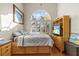 Bright bedroom featuring a built-in bed frame with drawer storage, an entertainment center, and a large arched window at 2309 Valrico Forest Dr, Valrico, FL 33594