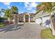 Stunning home featuring a paver driveway, manicured landscaping, and a three-car garage at 2309 Valrico Forest Dr, Valrico, FL 33594