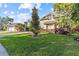 Well-manicured front yard with lush grass, a mature tree, and neatly trimmed landscaping at 2309 Valrico Forest Dr, Valrico, FL 33594
