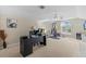 Spacious home office featuring a desk, exercise equipment, neutral walls, and large window at 2309 Valrico Forest Dr, Valrico, FL 33594