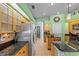 Bright kitchen features light wood cabinets, black countertops and appliances, and spacious walk through at 2309 Valrico Forest Dr, Valrico, FL 33594