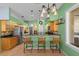 Bright kitchen features light wood cabinets, black countertops and appliances, and breakfast bar at 2309 Valrico Forest Dr, Valrico, FL 33594