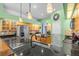 Bright kitchen features light wood cabinets, black countertops and appliances, and island with sink and breakfast bar at 2309 Valrico Forest Dr, Valrico, FL 33594