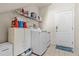 Laundry room with a modern washer and dryer set, overhead shelf, and a white door at 2309 Valrico Forest Dr, Valrico, FL 33594