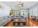 Bright living room features a large sectional, fireplace and is conveniently located off of the kitchen at 2309 Valrico Forest Dr, Valrico, FL 33594