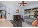 Comfortable living room features hardwood floors, a ceiling fan, and a sliding glass door at 2309 Valrico Forest Dr, Valrico, FL 33594