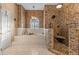 Elegant main bathroom with a soaking tub, tiled shower, and stone accent walls at 2309 Valrico Forest Dr, Valrico, FL 33594