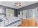 Bright main bedroom with tray ceilings, hardwood floors, and a view of the outdoor patio at 2309 Valrico Forest Dr, Valrico, FL 33594