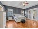 Charming main bedroom offers hardwood floors, ample natural light, and an ensuite bath at 2309 Valrico Forest Dr, Valrico, FL 33594