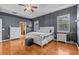 Spacious main bedroom featuring hardwood floors, a tray ceiling, and an ensuite bathroom at 2309 Valrico Forest Dr, Valrico, FL 33594