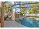 Inviting pool with rock waterfall feature and lush landscaping, perfect for relaxation and recreation at 2309 Valrico Forest Dr, Valrico, FL 33594