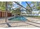Beautiful screened-in pool with rock waterfall feature, providing a serene and private oasis at 2309 Valrico Forest Dr, Valrico, FL 33594