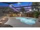 Beautiful screened-in pool with a waterfall feature and spacious deck, perfect for outdoor relaxation and entertaining at 2309 Valrico Forest Dr, Valrico, FL 33594