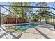Screened-in pool area with a stunning rock waterfall feature and a privacy fence for outdoor enjoyment at 2309 Valrico Forest Dr, Valrico, FL 33594