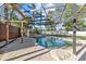 Enclosed pool area with rock waterfall and lush landscaping creates a private backyard paradise at 2309 Valrico Forest Dr, Valrico, FL 33594