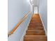 Staircase featuring wood floors, a handrail, and light blue walls at 2309 Valrico Forest Dr, Valrico, FL 33594