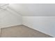 This is an empty attic with carpet and slanted ceilings at 2646 Barksdale Ct, Clearwater, FL 33761