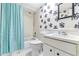 Cozy bathroom with floral accent wall, shower-tub combo, vanity, and sink at 2646 Barksdale Ct, Clearwater, FL 33761