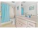 Well-lit bathroom with shower-tub combo, single sink vanity, and bright lighting at 2646 Barksdale Ct, Clearwater, FL 33761
