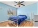 Bright bedroom with large window, laminate floors, and simple decor at 2646 Barksdale Ct, Clearwater, FL 33761