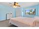 Bright bedroom featuring a ceiling fan, a window with blinds, and a dresser at 2646 Barksdale Ct, Clearwater, FL 33761