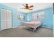 The bedroom is naturally lit with carpet flooring, ceiling fan and standard closet at 2646 Barksdale Ct, Clearwater, FL 33761