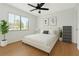 Bright bedroom features a ceiling fan, minimalist decor, and a large window with natural light at 2646 Barksdale Ct, Clearwater, FL 33761