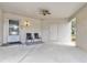 The large carport with ceiling fan and two seats provides ample space for parking and outdoor seating at 2646 Barksdale Ct, Clearwater, FL 33761
