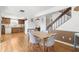 Dining area with table and chairs near kitchen, stairs, and living area at 2646 Barksdale Ct, Clearwater, FL 33761