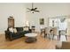 Bright and stylish living room featuring high ceilings, ceiling fan, hardwood floors, comfortable seating, and plenty of natural light at 2646 Barksdale Ct, Clearwater, FL 33761