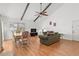 A combined living and dining room, with vaulted ceiling and wood beams is open and inviting at 2646 Barksdale Ct, Clearwater, FL 33761