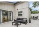 A beautifully designed outdoor patio features neutral furniture, neutral pavers and access to dining room through sliding glass doors at 2646 Barksdale Ct, Clearwater, FL 33761