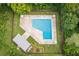 Aerial view of a community pool with lounge chairs and mature landscaping at 2646 Barksdale Ct, Clearwater, FL 33761