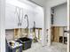 Bathroom featuring white walls, toilet, wire shelving and doorway at 2827 W Bay Haven Dr, Tampa, FL 33611