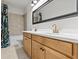 Bright bathroom featuring double sinks, framed mirror and shower with decorative curtain at 28889 Orange Berry # Dr, Wesley Chapel, FL 33543