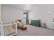 Cozy Bedroom features a crib, glider, and changing table, perfect for a new Gathering at 28889 Orange Berry # Dr, Wesley Chapel, FL 33543