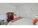 Simple bedroom with an accent blanket on the bed, with a view towards another room at 28889 Orange Berry # Dr, Wesley Chapel, FL 33543