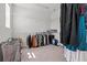 Walk-in closet providing ample storage with installed metal shelving and hanging rods at 28889 Orange Berry # Dr, Wesley Chapel, FL 33543